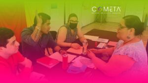 Group of people engaging in a discussion around a table, representing the participatory approach in organizational processes.