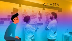 Dos facilitadores, de pie frente a grandes hojas cubiertas con notas adhesivas durante un taller de reflexión estratégica, ilustran la aplicación de la Metodología de Futuros para la construcción de escenarios y la planificación organizacional. El logotipo de COMETA aparece en la esquina superior derecha, y un personaje ilustrado a color observa la discusión en el lado izquierdo de la imagen.